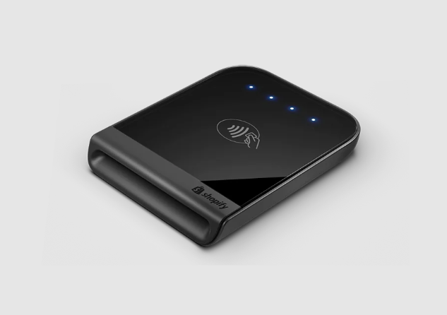 The EOM-POS Shopify Tap & Chip Card Reader is a black device with three blue indicator lights and a contactless payment symbol on top, designed for seamless payments, shown against a light gray background.